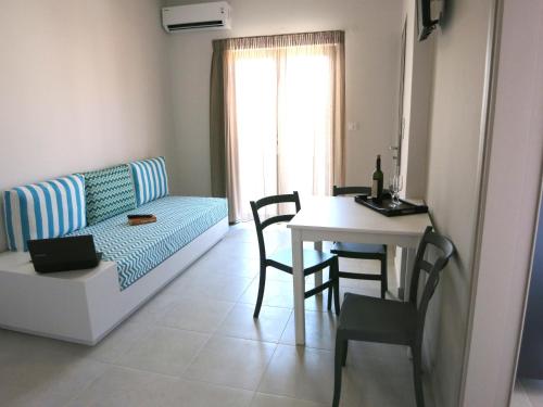 a living room with a couch and a table at Amaryllis in Plataniás