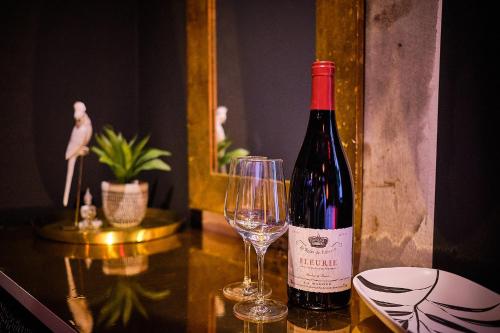 a bottle of wine and a glass on a table at The Emerald Suite by Margate Suites in Margate