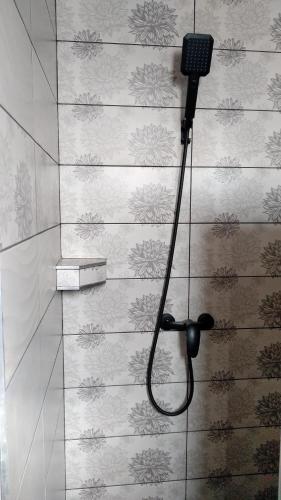 a blow dryer on a wall in a bathroom at Margaréta Panzió in Sárospatak