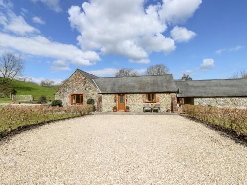 a large stone house with a gravel driveway at The Old Dairy in Newport