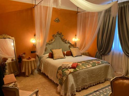 a bedroom with a large bed and a large window at Agri-Relais Sotto il cielo di Toscana only adults in Camaiore