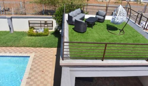 a view of a backyard with a swimming pool at Homey Guesthouse in Gaborone