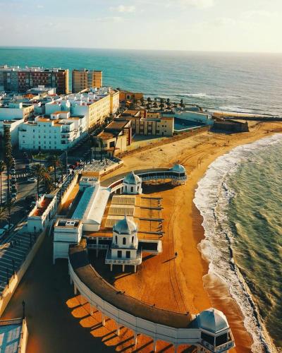 an aerial view of a beach with buildings and the ocean at No 14 Cádiz in Cádiz