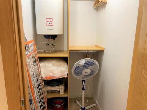 a closet with a fan and a water heater at No 14 Cádiz in Cádiz