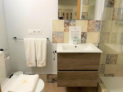 a bathroom with a sink and a toilet at No 14 Cádiz in Cádiz