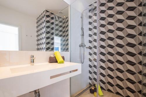 a bathroom with a sink and a shower at Villa Benagil Boutique by Algarve Vacation in Carvoeiro