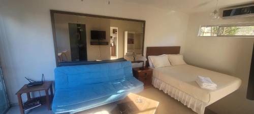 a small bedroom with a bed and a mirror at SUITE 1 CLUB CAMPESTRE in Santa Cruz de la Sierra