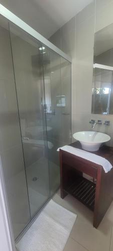 a bathroom with a glass shower and a sink at SUITE 1 CLUB CAMPESTRE in Santa Cruz de la Sierra
