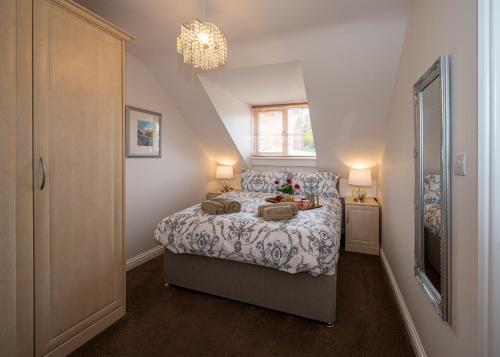 a bedroom with a bed and a window at Estuary View in Whitby