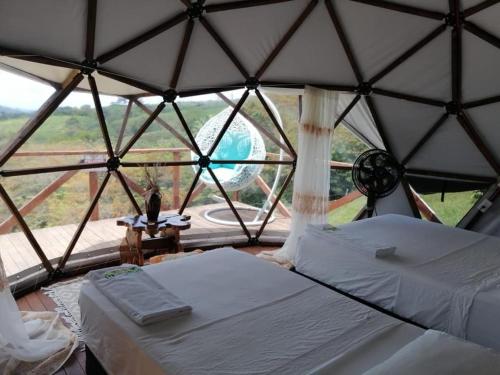 a room with two beds in a yurt at Eco-Glamping Shalom in Mariquita