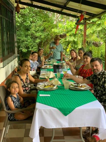 a group of people sitting at a table eating at Eco-Glamping Shalom in Mariquita