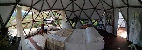 a bedroom in a yurt with a bed in it at Eco-Glamping Shalom in Mariquita