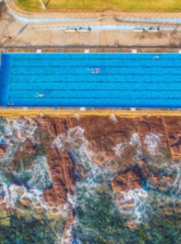 a blue bench sitting on top of a table at SHELLHARBOUR BEACH COTTAGE - Stroll to Beach flags - Back gate straight to Beach, Front gate walk to new Marina in Shellharbour