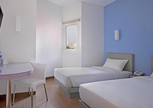 Amaris Hotel Juanda tesisinde bir odada yatak veya yataklar