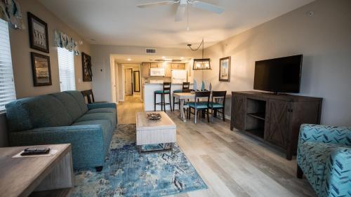 a living room with a couch and a tv at Holiday Inn Club Vacations Cape Canaveral Beach Resort in Cape Canaveral
