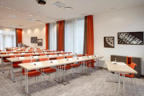 a classroom with desks and chairs in a room at Holiday Inn Berlin City East Side by IHG in Berlin
