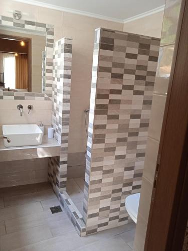 a bathroom with a sink and a toilet and a mirror at To limanaki in Finikounta