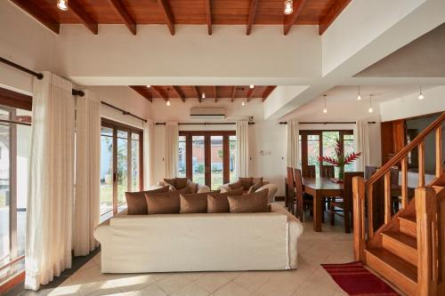 a living room with a couch and a table at The Beach Villas by Ceylon Bungalows in Wadduwa