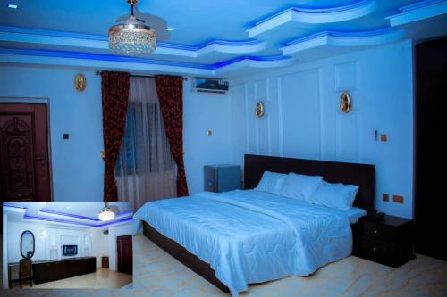 a bedroom with a large bed with blue lighting at Mexiloyd Hotel - Deluxe Studio in Port Harcourt