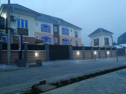 una casa con una valla delante en Blooms Spot Hotel - Self Service Apartment, en Port Harcourt