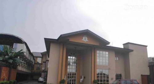 a building with a car parked in front of it at The Golf Prince Hotel in Port Harcourt