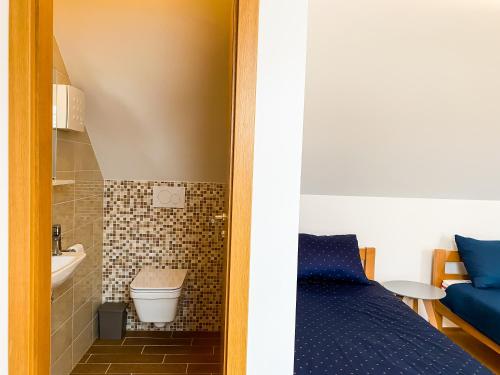 a small bathroom with a toilet and a sink at Lakeview Villa Bled in Bled