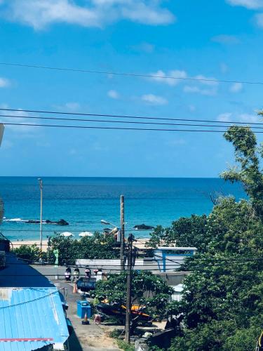 a view of a beach with the ocean in the background at 海灘戀情 Beach Love 近沙灘-國旅卡特約商店 陽台房 希臘地中海風格 in Eluan