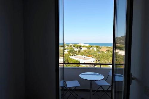 a balcony with a table and a view of the ocean at Hotel Piccolo Paradiso in Peschici