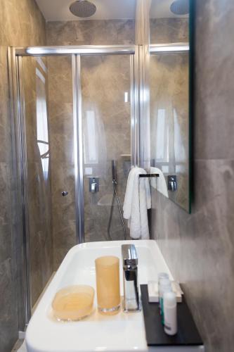 a bathroom with a white sink and a shower at BB De Rohan in Żebbuġ