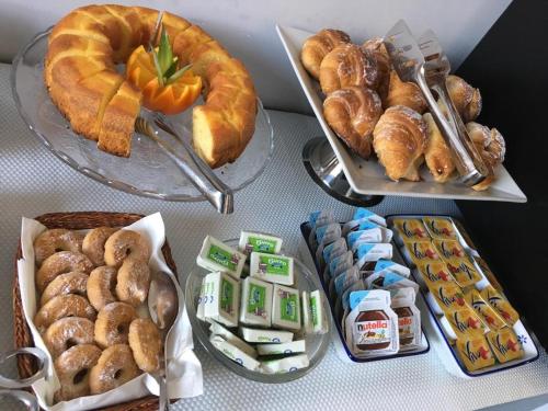 a table topped with different types of pastries and bread at Roma Veneto Relais in Rome