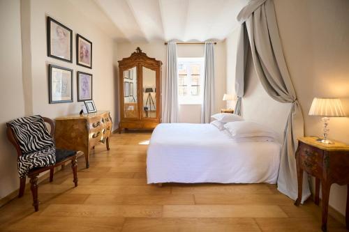 une chambre avec un lit, une chaise et un miroir dans l'établissement Gites de charme à la campagne, à Lemps