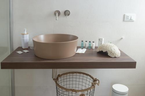 a sink on a wooden counter in a bathroom at Marezè in Punta Secca