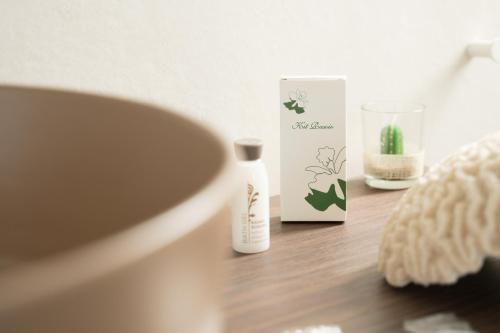 a bathroom with a bottle of moisturizing moisturizers on a table at Marezè in Punta Secca
