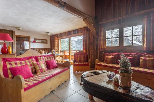 a living room with a couch and a table at La Grange de Marie in Les Allues