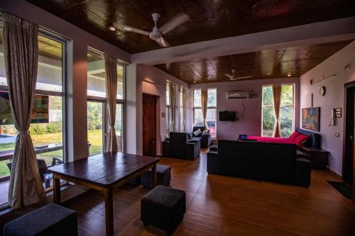 a living room with a table and a couch at Waves Beach House in Puducherry