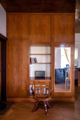 a living room with a wooden desk and a chair at Waves Beach House in Puducherry