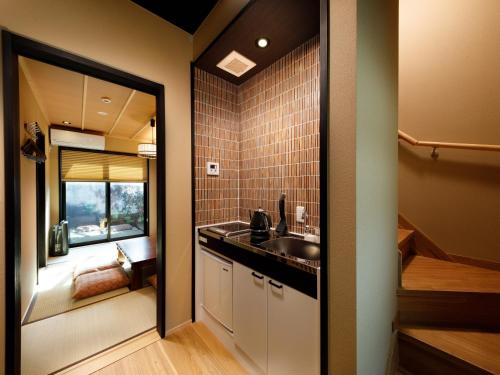 a bathroom with a sink and a mirror at Kanade Fushimiinari-Inometei in Kyoto