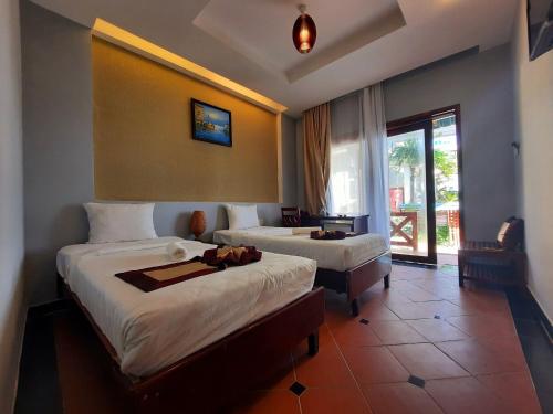 Giường trong phòng chung tại Thai Hoa Mui Ne Resort