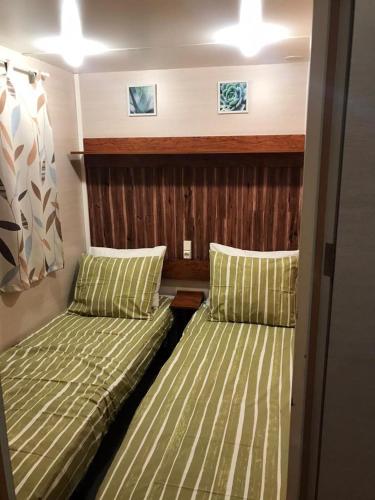 two beds in a small room in a boat at Lila House in Xàtiva