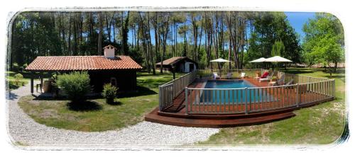 a backyard with a pool and a gazebo at Au Clair Des Landes in Castets