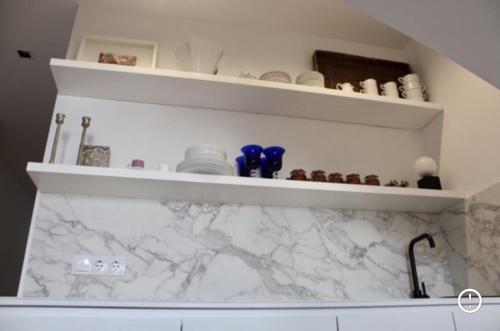 a kitchen with white marble shelves and a sink at PLAZA CABILDO 4 in Sanlúcar de Barrameda