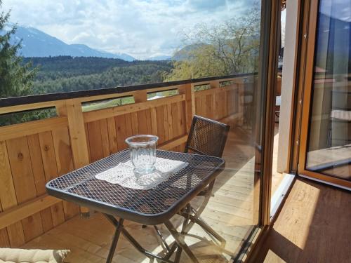 a table and chair on a balcony with a view at Zauscherhof in Wildermieming