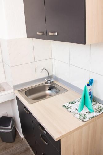 a kitchen with a sink and a counter top at Ferienwohnung am Alten Hafen in Wismar