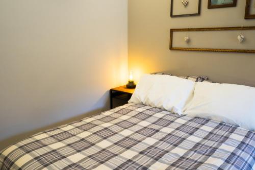a bedroom with a bed and a lamp on a night stand at Locanda Vecchio Cipresso in Chiaverano