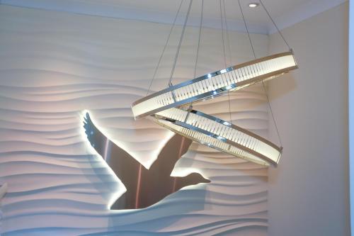 a chandelier hanging from a wall in a room at Duck Bay Hotel & Restaurant in Balloch