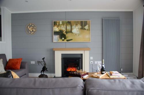 a living room with a couch and a fireplace at Hollicarrs - Honeycomb Lodge in York