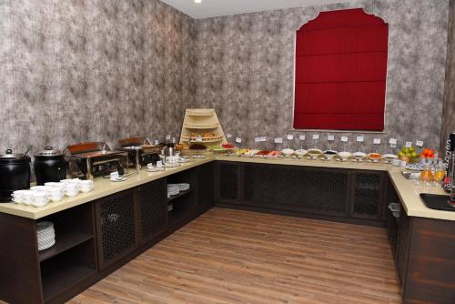 a dining room with a table with food on it at Macara Sheki City Hotel in Sheki