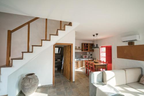a living room with a white couch and a staircase at Monte Gois Country House e Spa in Curvatos