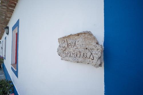 a sign on the side of a white building at Monte Gois Country House e Spa in Curvatos