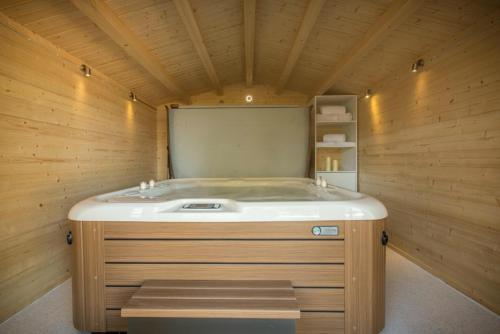 a sauna with a sink in a wooden room at Duck Bay Hotel & Restaurant in Balloch